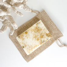 Load image into Gallery viewer, Handcrafted oatmeal citrus soap bar with lemon eucalyptus essential oil and chamomile flowers
