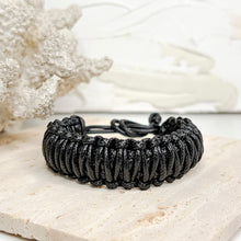 Load image into Gallery viewer, Unisex adjustable macramé bracelet with wooden beads in black and brown woven cord design
