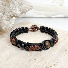 Load image into Gallery viewer, Unisex adjustable macramé bracelet with wooden beads in black and brown woven cord design
